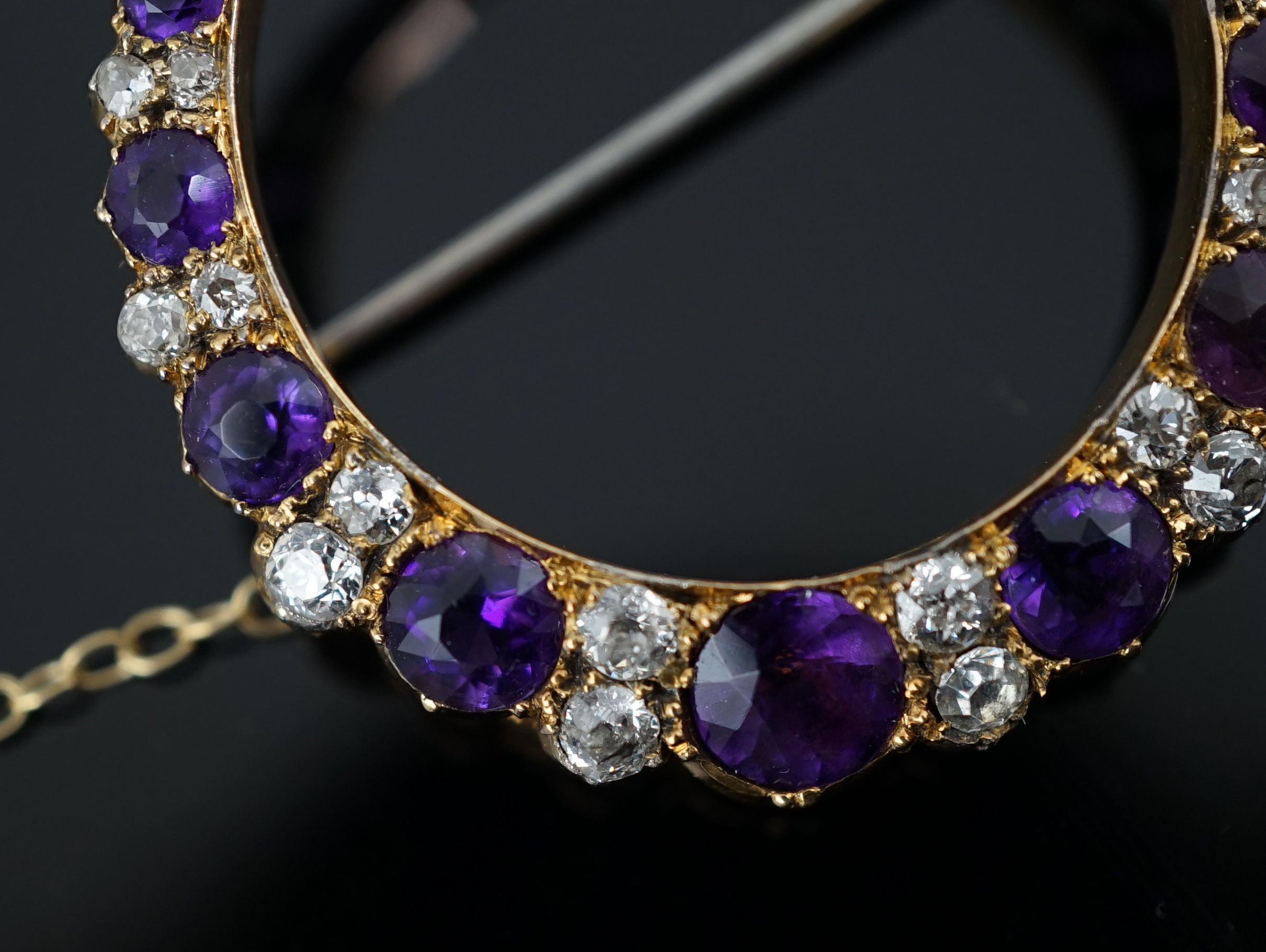 A late Victorian gold, graduated amethyst and diamond cluster set crescent brooch